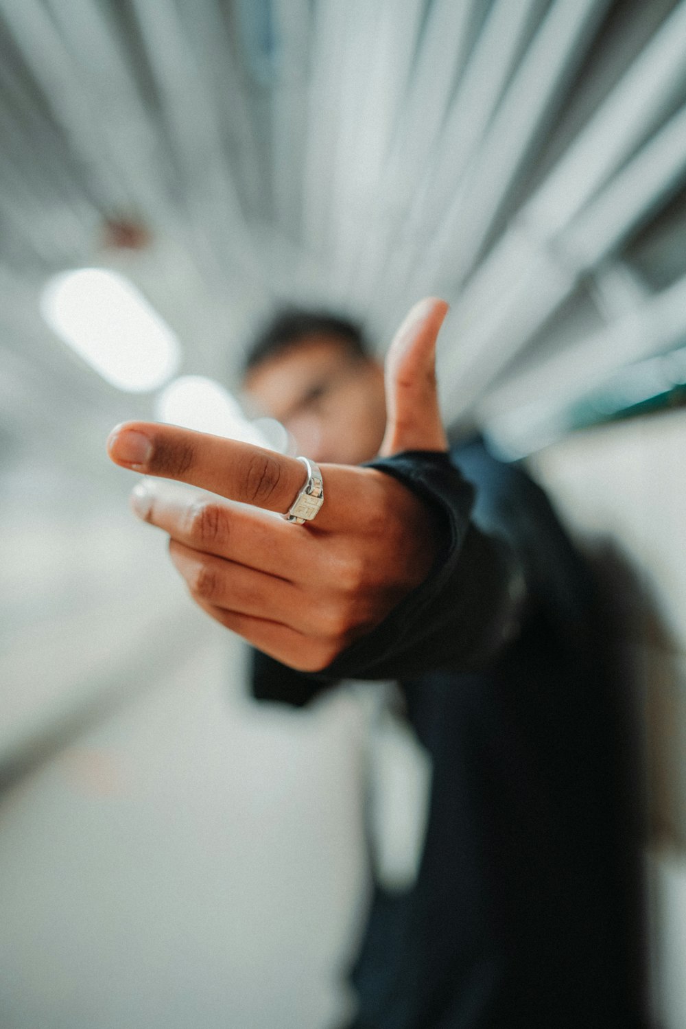 a man in a suit is holding out his hand