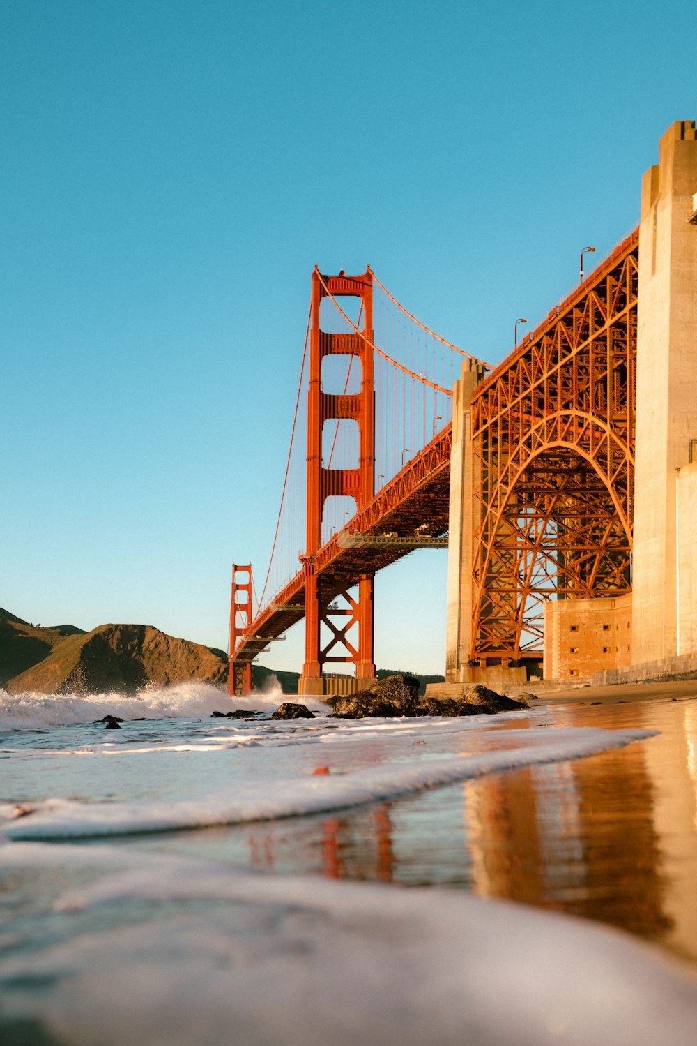 a view of the golden gate bridge from the beach