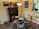 A warm, inviting dining set with wooden table and cushioned chairs in a cozy room.