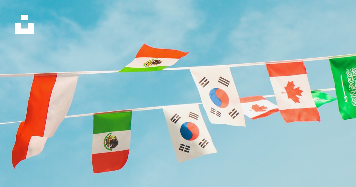 A bunch of flags that are flying in the air photo – Free Flag Image on ...