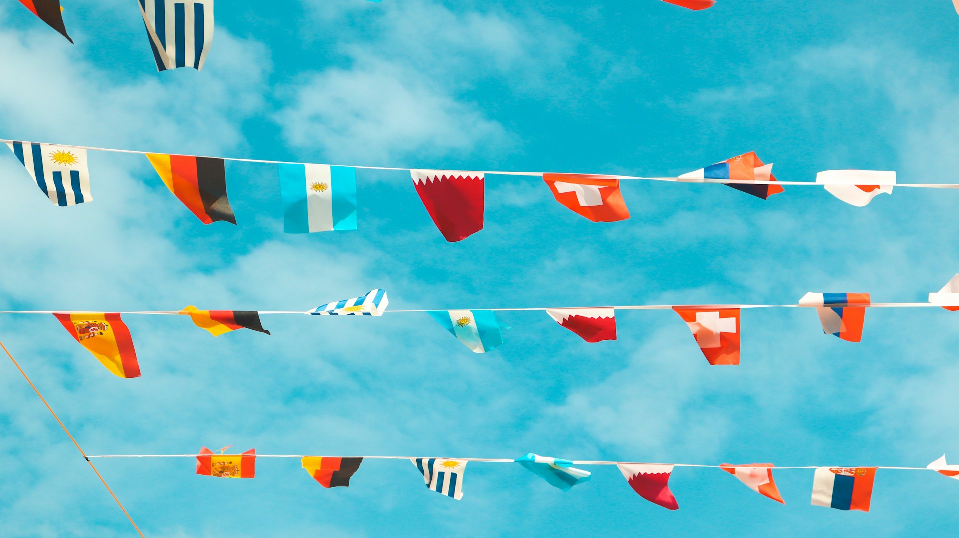 woman wearing yellow long-sleeved dress under white clouds and blue sky during daytime