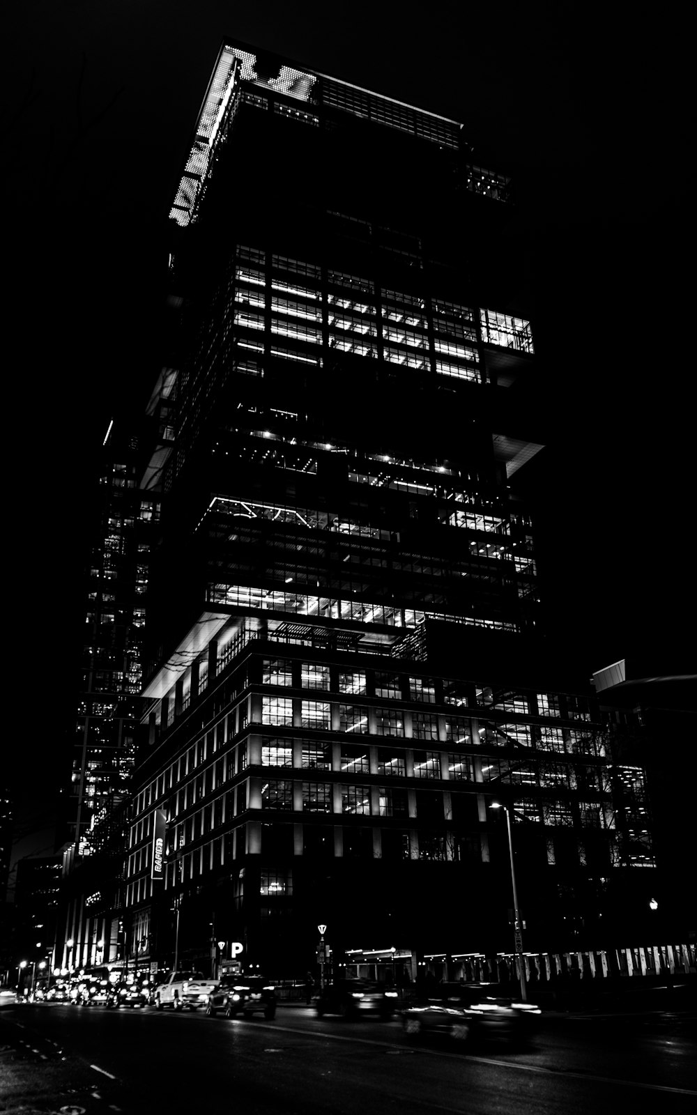 a black and white photo of a building at night