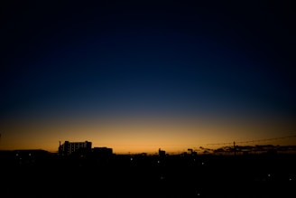 A futuristic city skyline with a subtle blue gradient background.