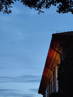 Evening shot of a home with a newly installed roof glowing softly in warm light.