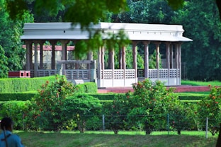 a gazebo in the middle of a lush green park