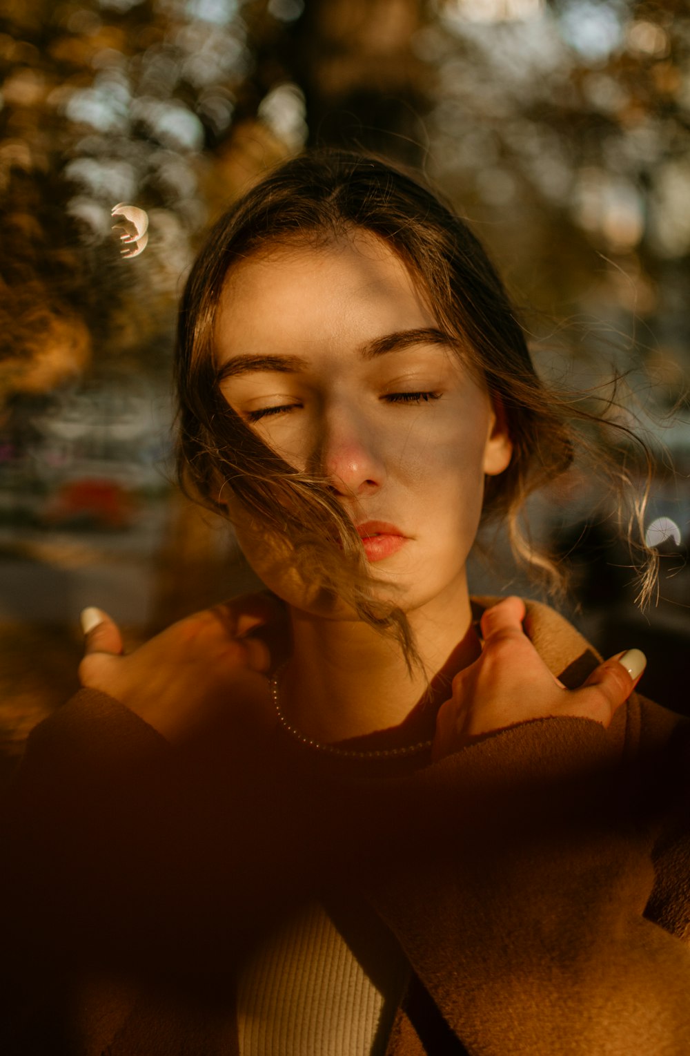 a woman with her eyes closed looking down