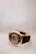 Elegant wristwatch with a black leather strap and golden details resting on a marble surface.