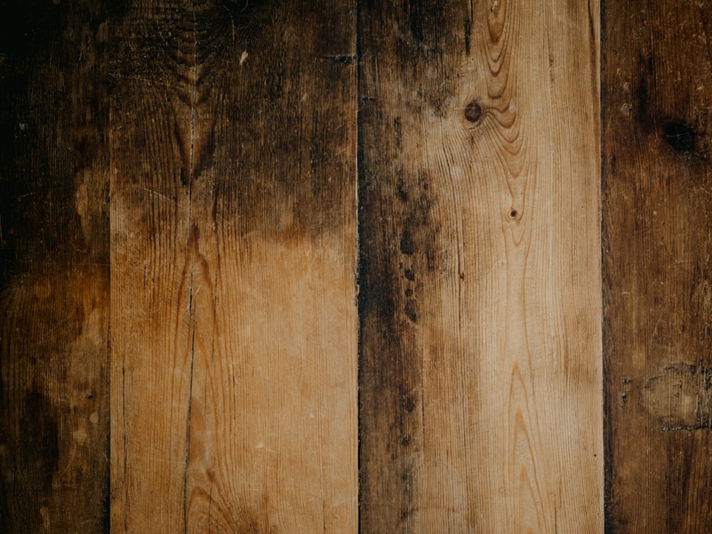 a close up of a wooden wall with a clock on it