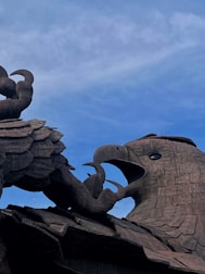 a statue of an elephant and a bird on top of a building
