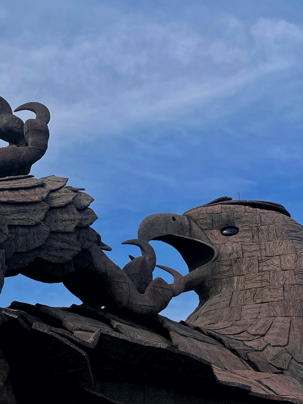 a statue of an elephant and a bird on top of a building