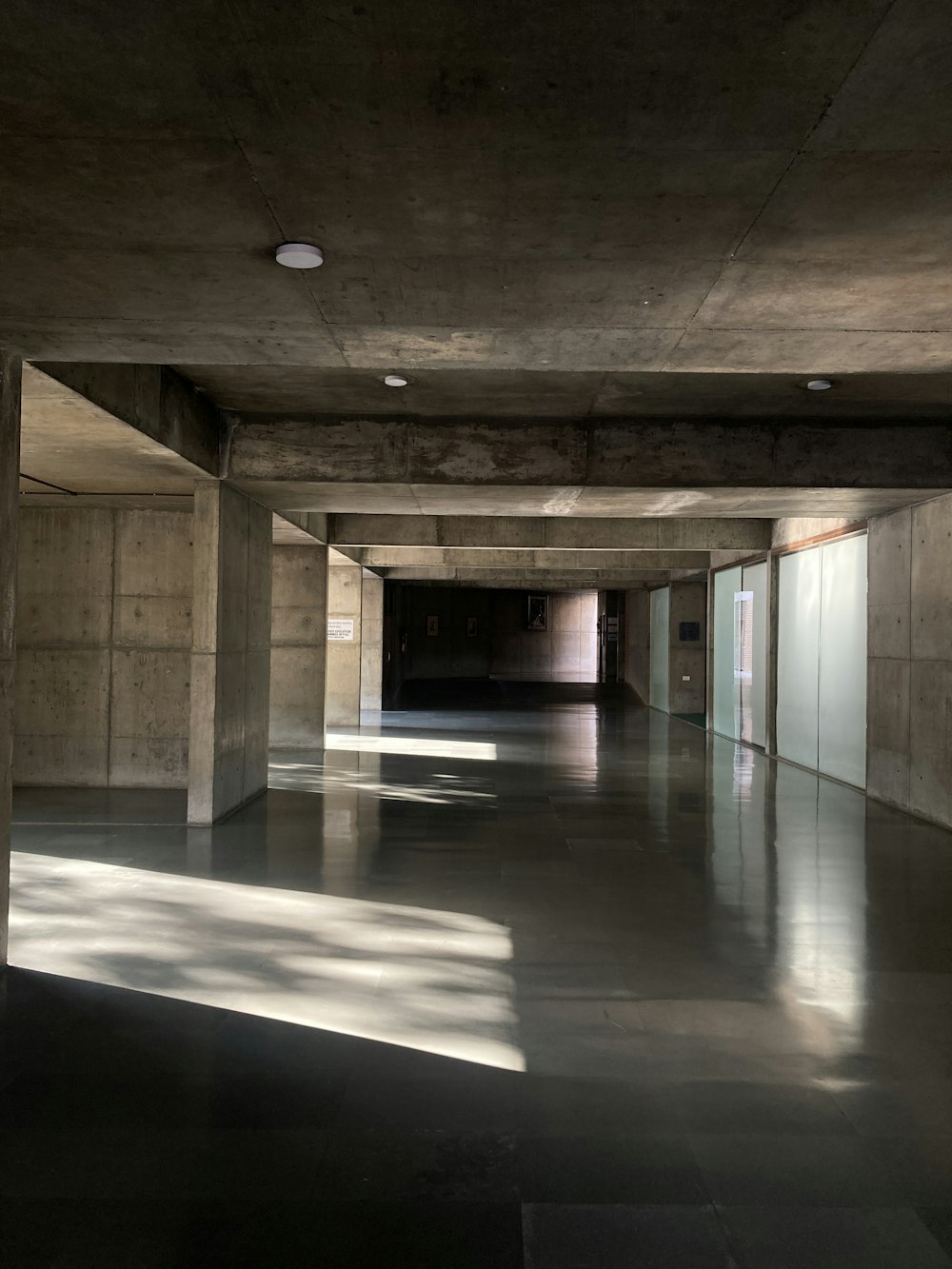 an empty room with concrete walls and floors
