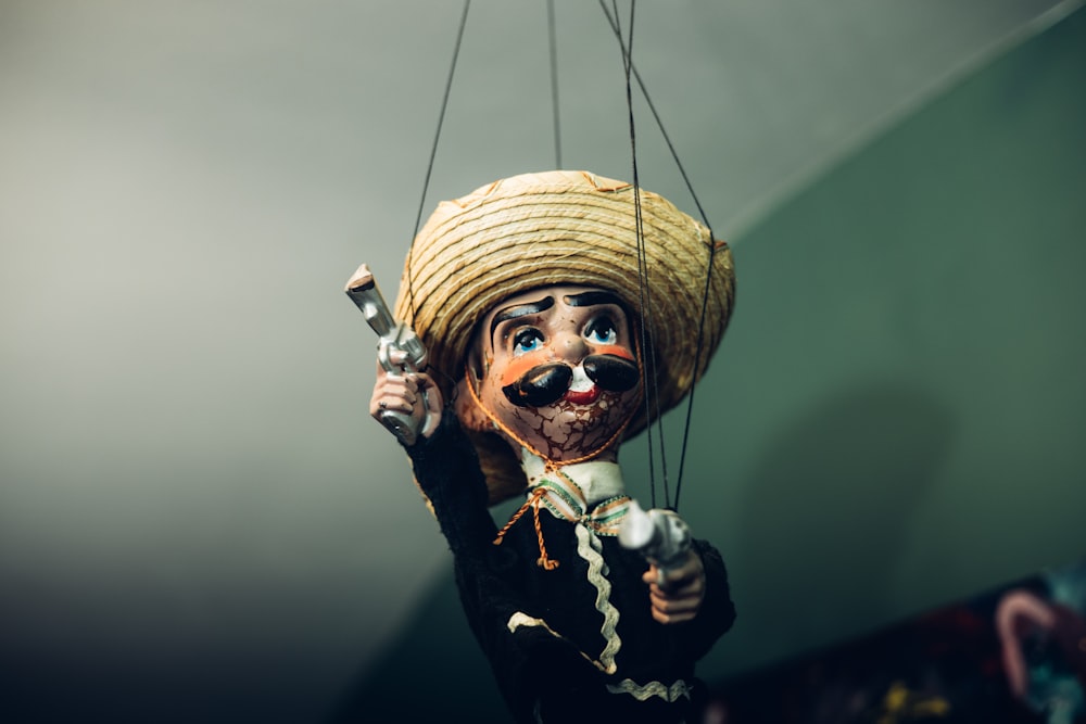 a scarecrow with a straw hat holding a knife
