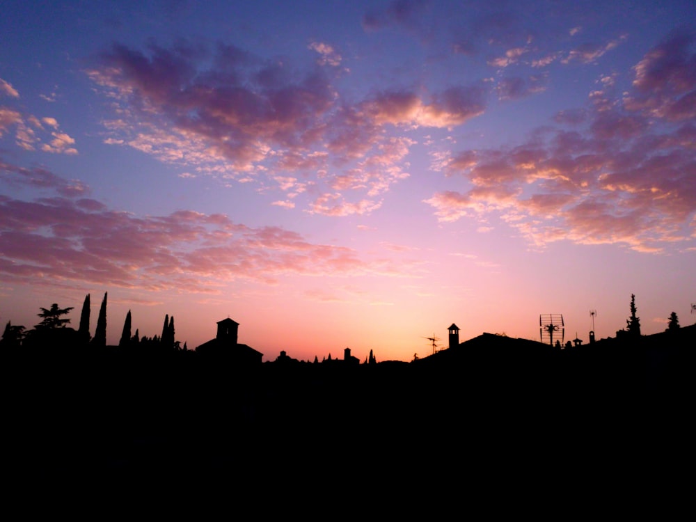 the sun is setting over a small town