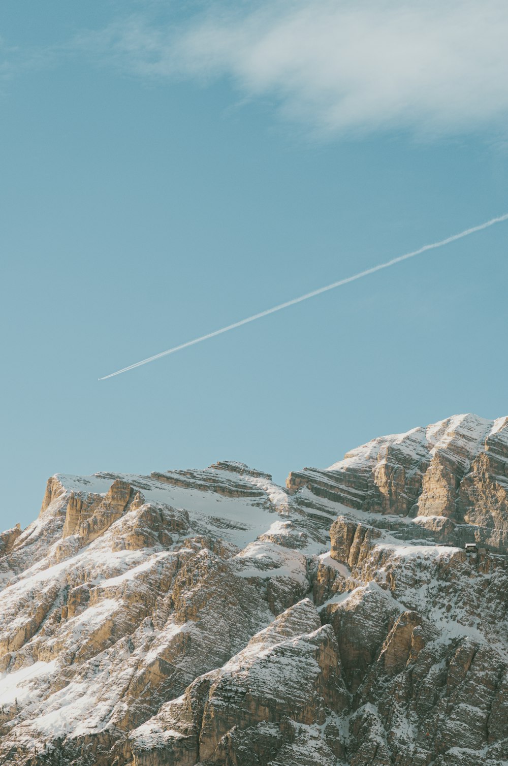 a plane flying over a snow covered mountain