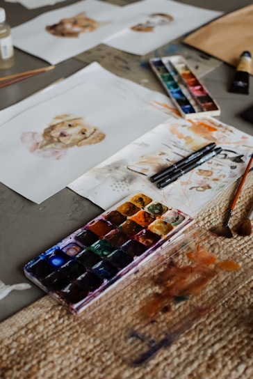 a table topped with lots of art supplies