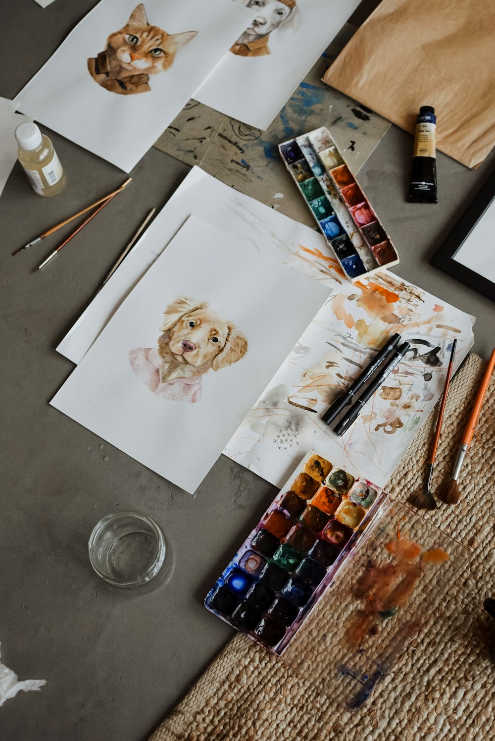 a table topped with lots of art supplies