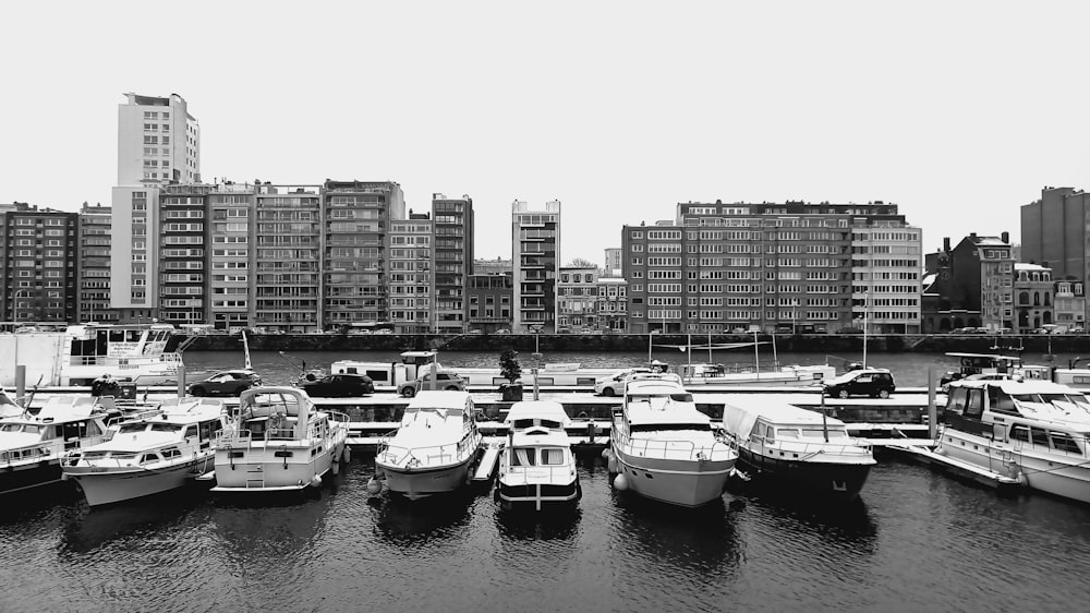 a black and white photo of boats docked in a harbor