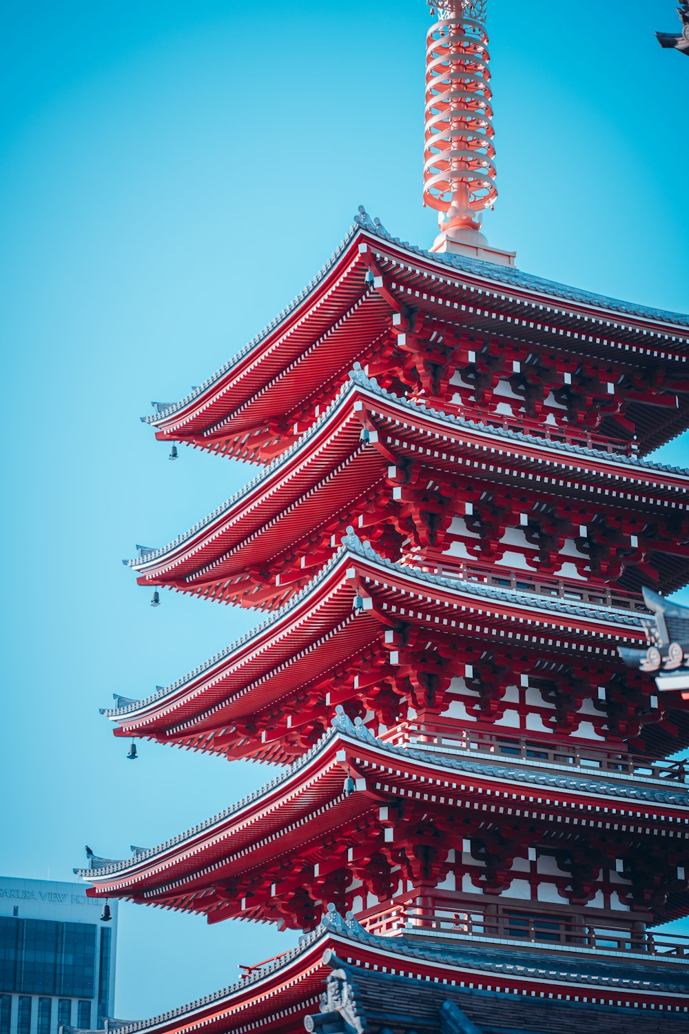 a tall red pagoda with a sky background