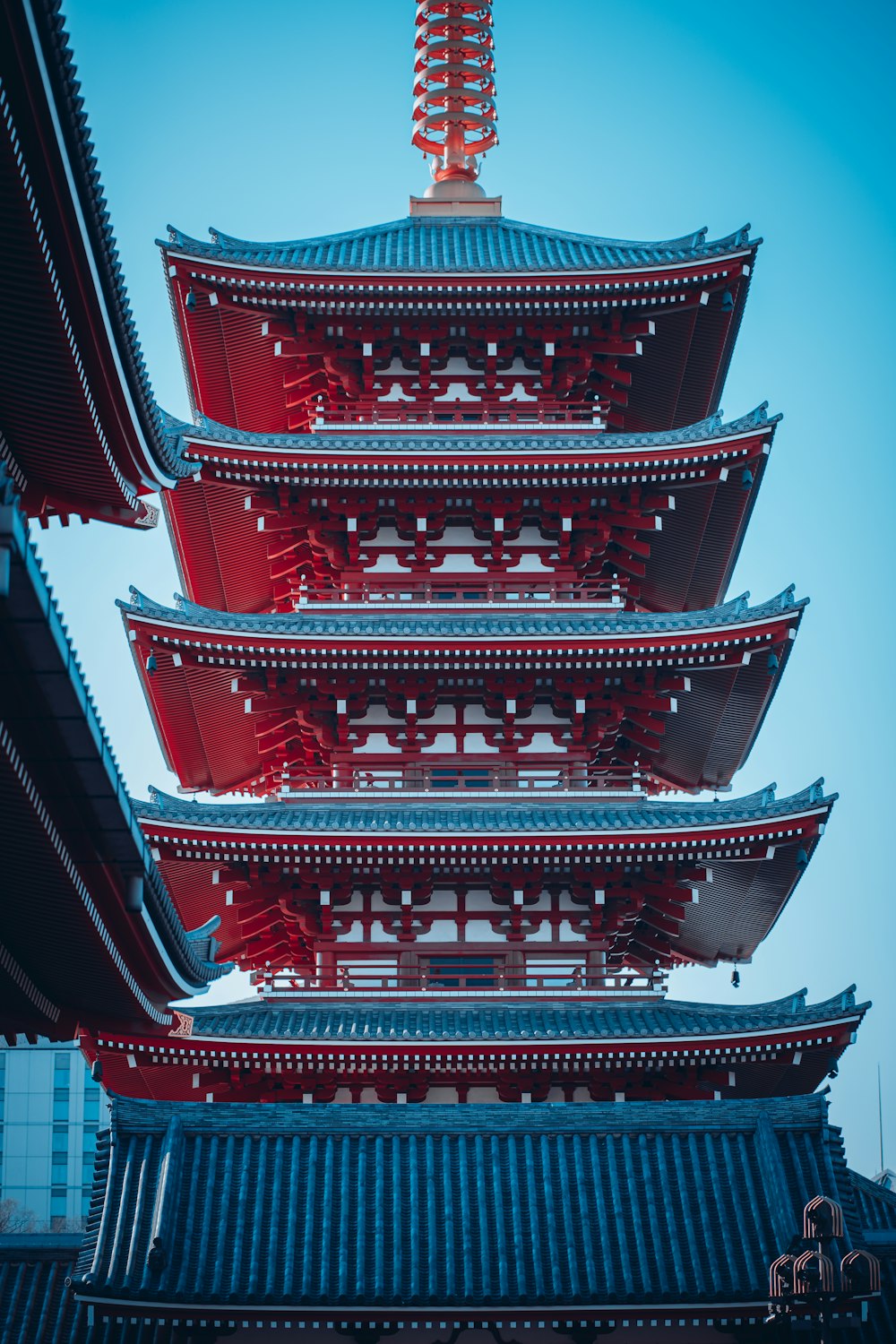 a tall building with a red roof on top of it