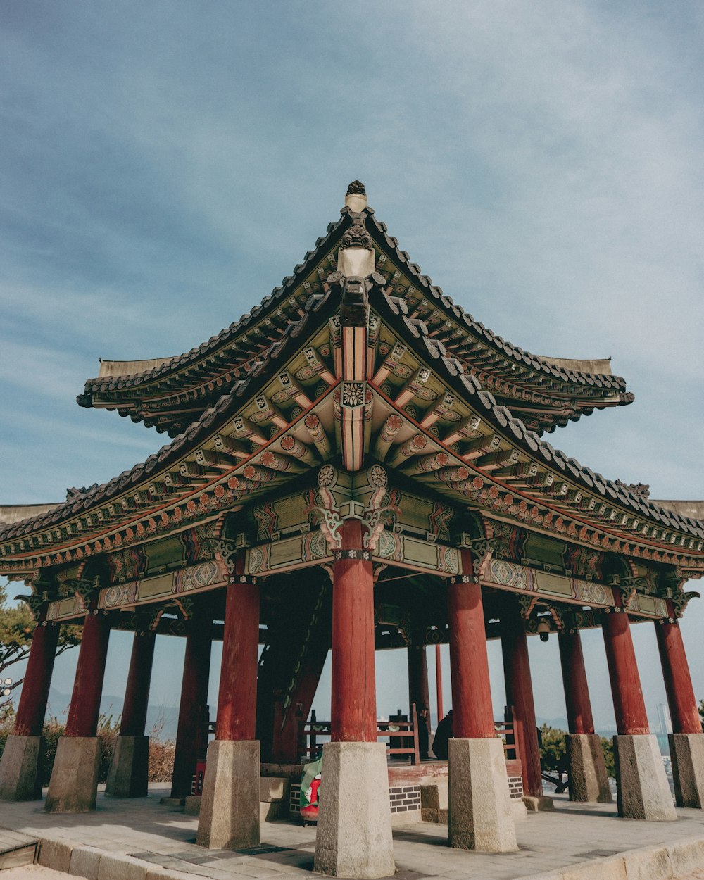 a tall red and white building sitting under a blue sky