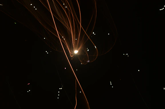 A sleek dark charcoal background with glowing orange lines forming a network of connected data points.