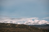 A panoramic view of majestic mountains under a clear blue sky.