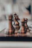A close-up of chess pieces on a stylish board.