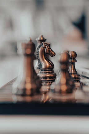 A close-up of chess pieces on a stylish board.