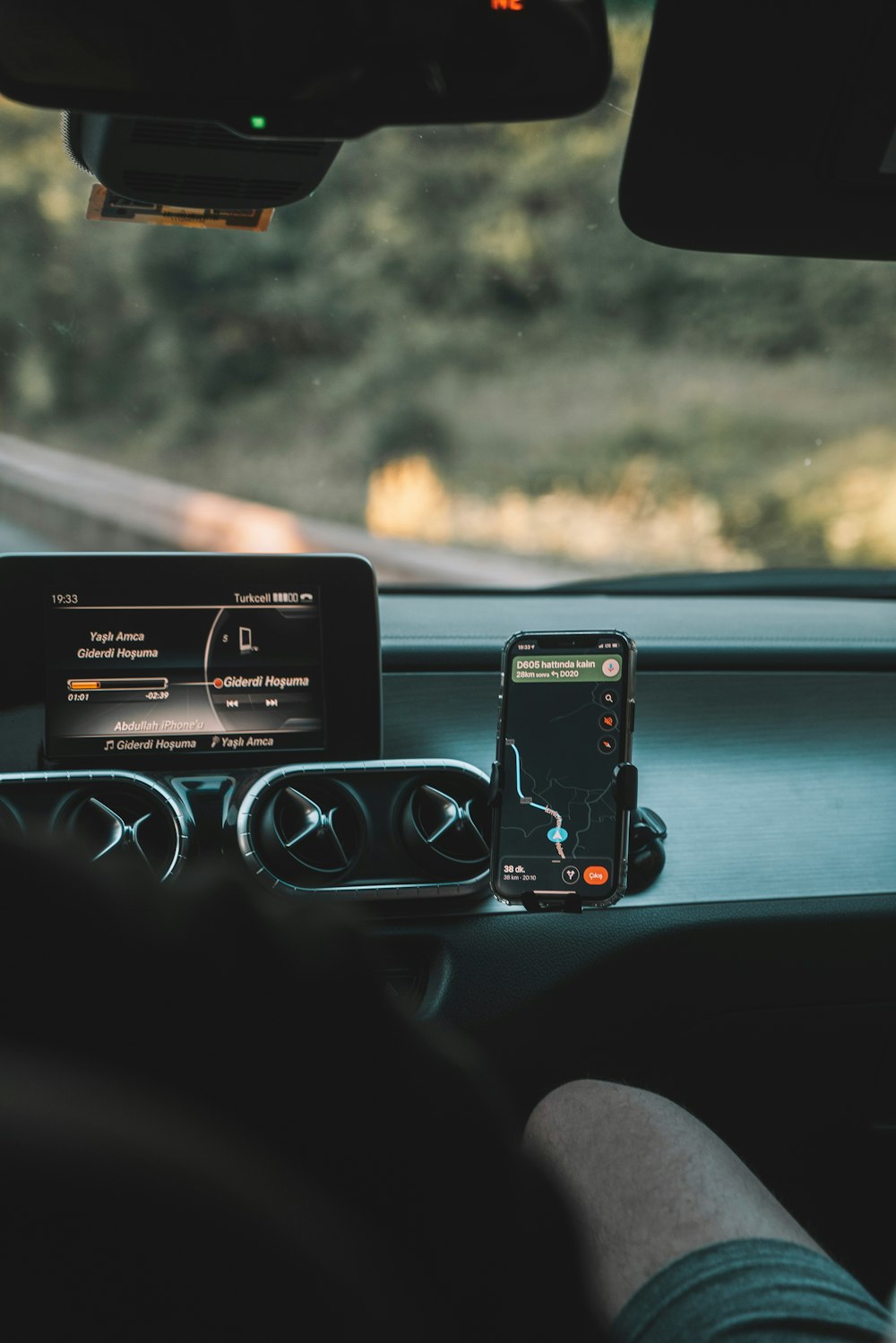 a car dashboard with a cell phone and gps