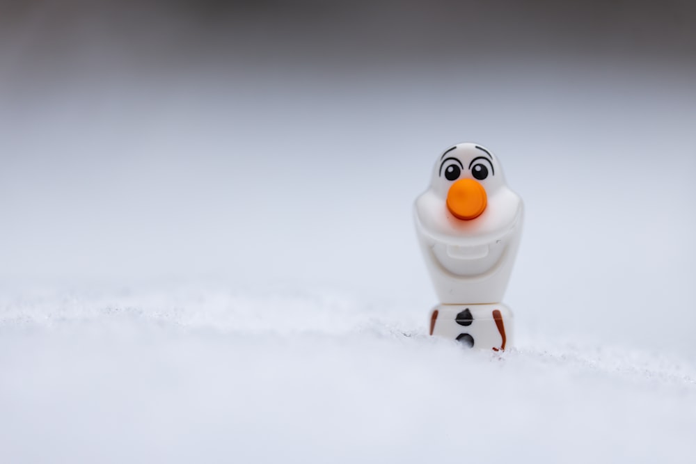 a close up of a toy figure in the snow