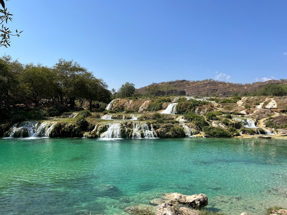 a body of water with a waterfall in the background