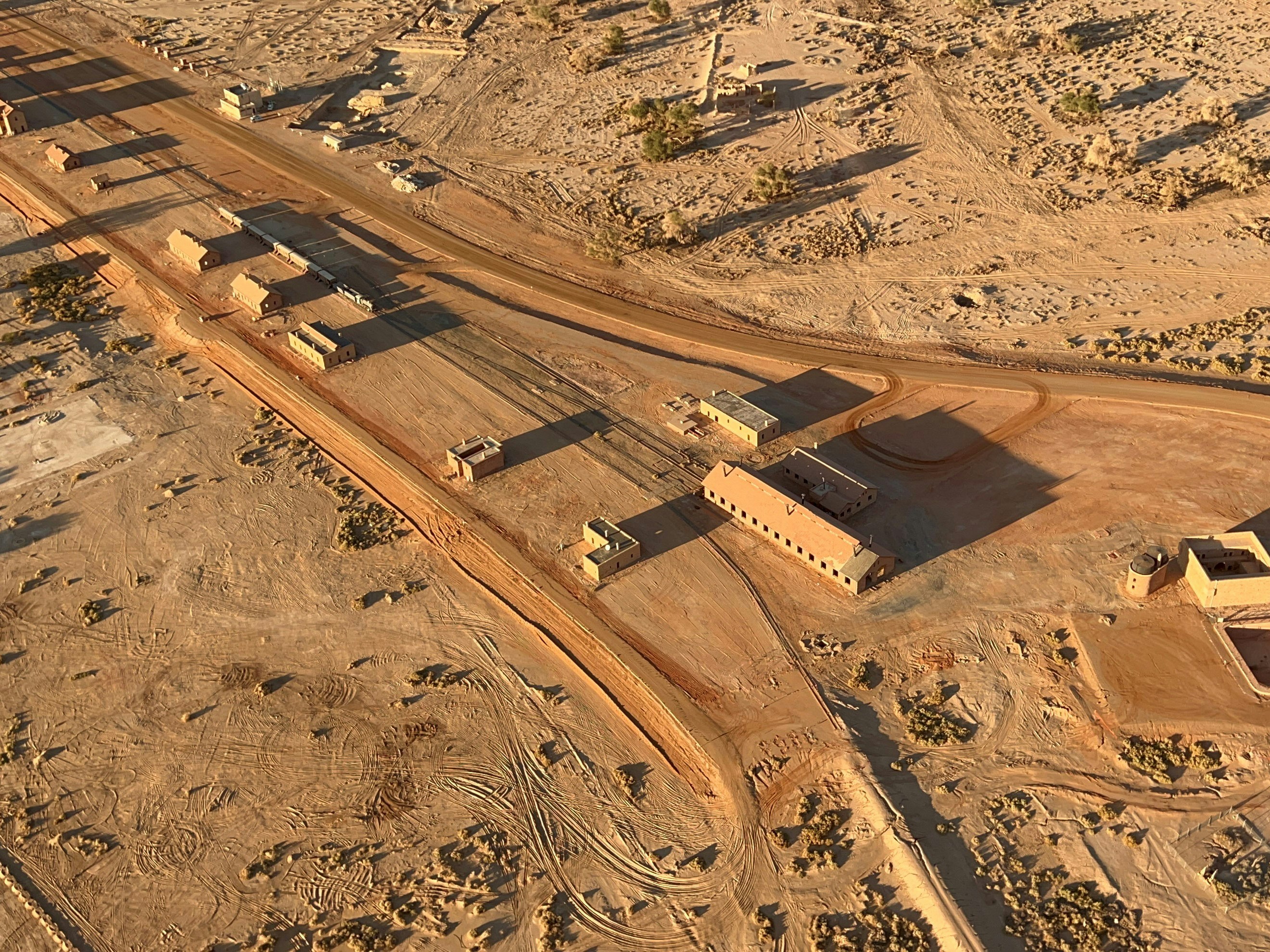 an aerial view of a desert town in the middle of the desert, A majestic view of the desert lands of AlUla, Saudi Arabia