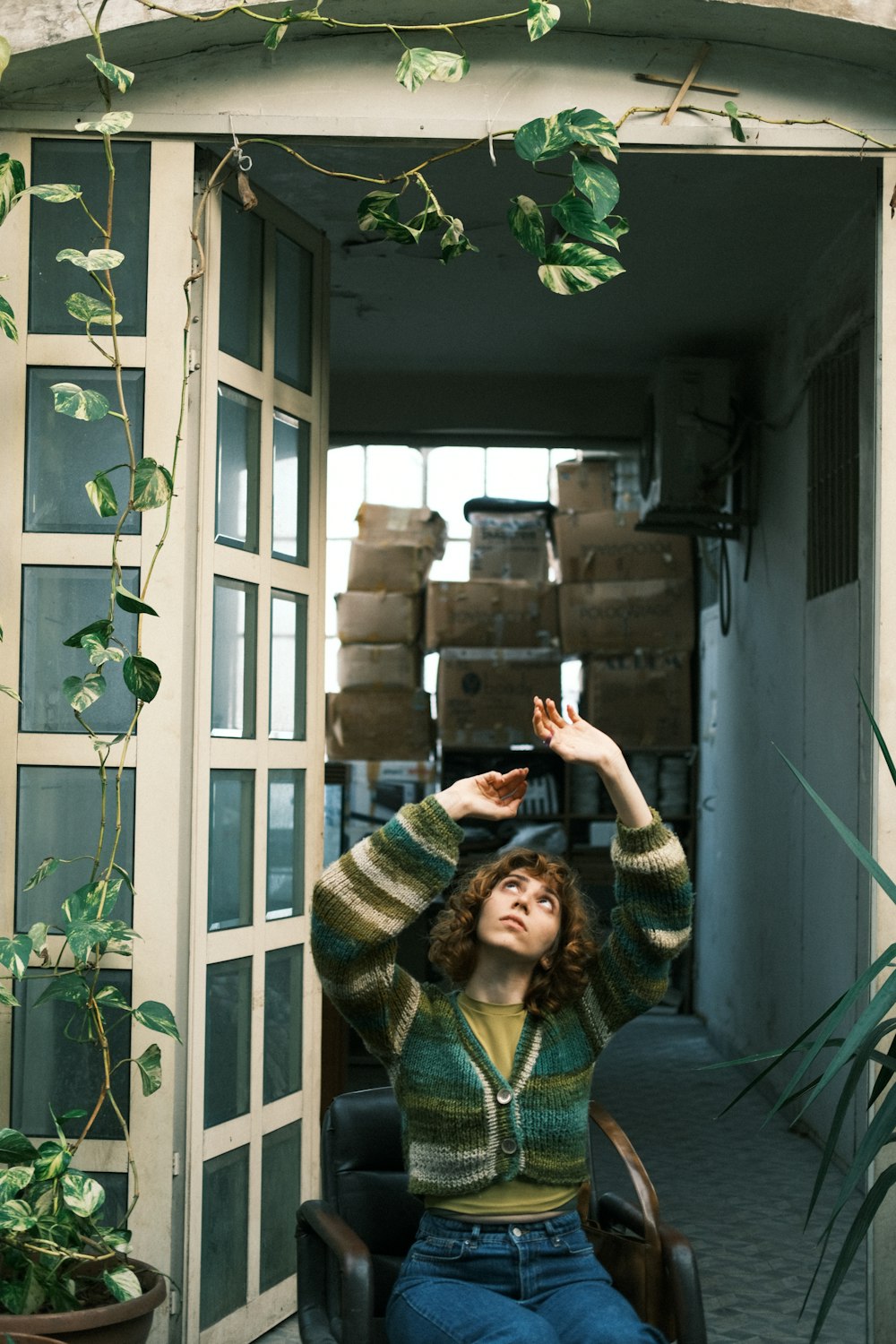 a woman sitting in a chair in front of a doorway