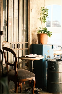 A bright, modern coffee shop corner with a person reading a book.