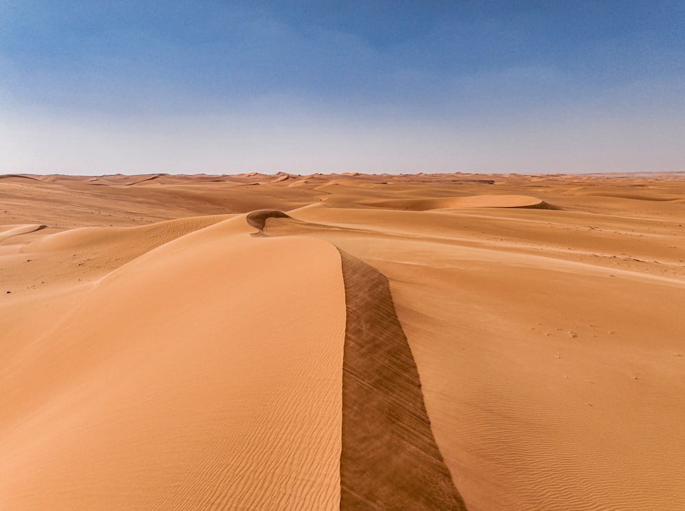 a large sandy area with a sky in the background