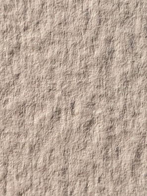 Artistic shot of raw canvas texture blended with warm earth tones.