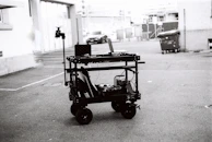 Group Onix technician testing an analog security camera with a handheld monitor in a parking garage.