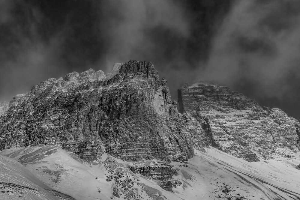 a black and white photo of a snow covered mountain