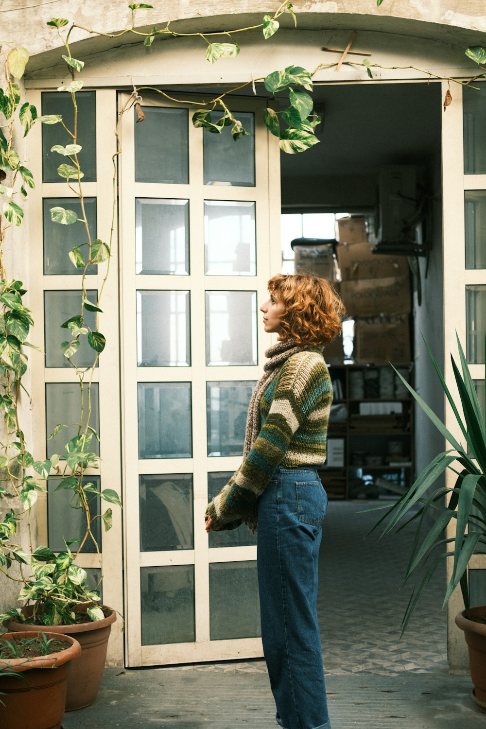 a woman standing in front of a glass door