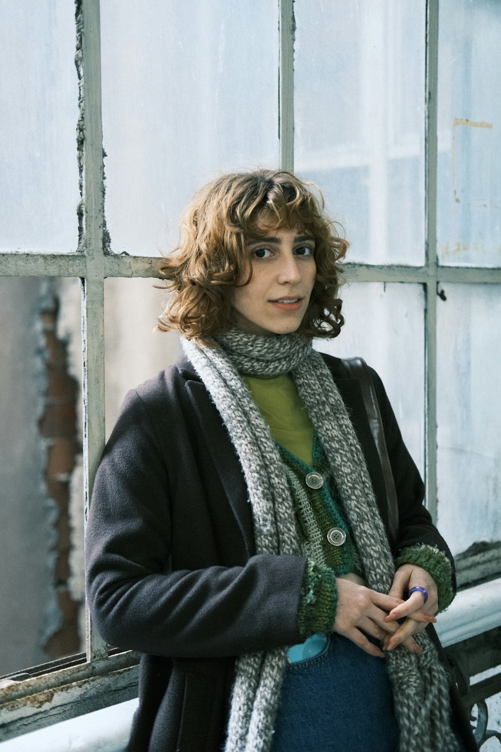 a woman standing in front of a window