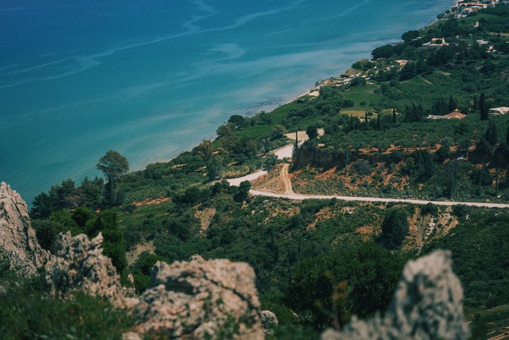 a scenic view of a winding road near a body of water