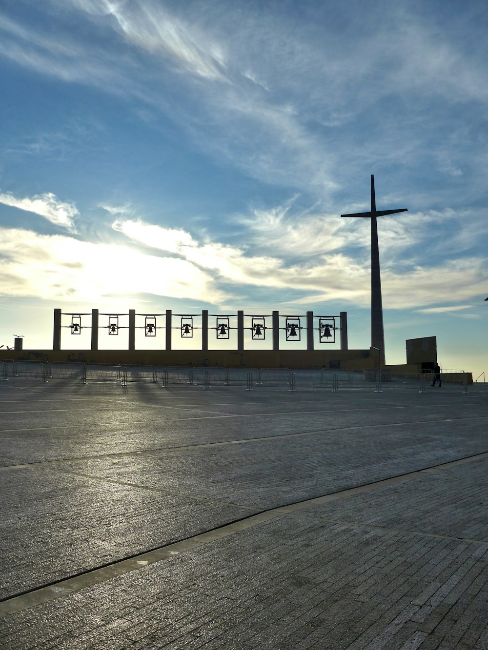 a cross on top of a building with a sky background