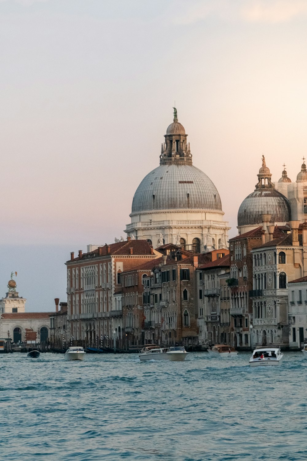 a large body of water with a bunch of buildings in the background