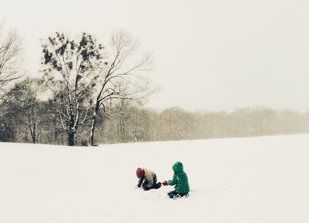 a couple of kids playing in the snow