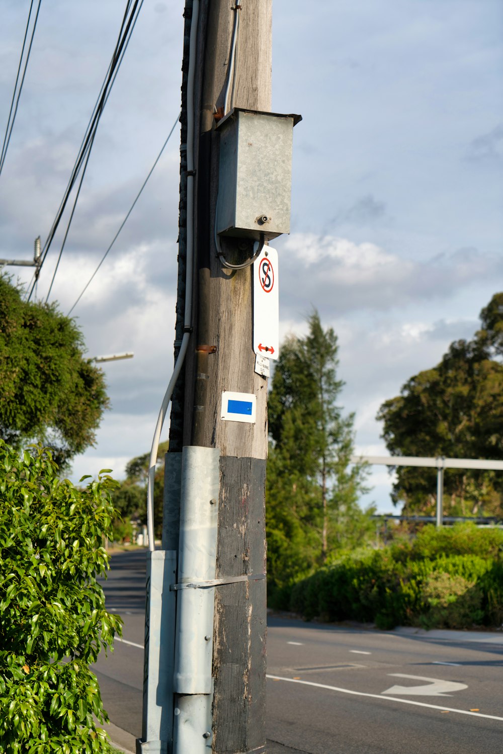 a telephone pole with a no parking sign on it