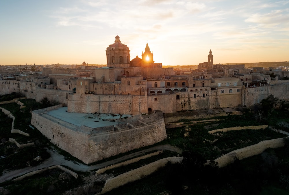 the sun is setting over a large city