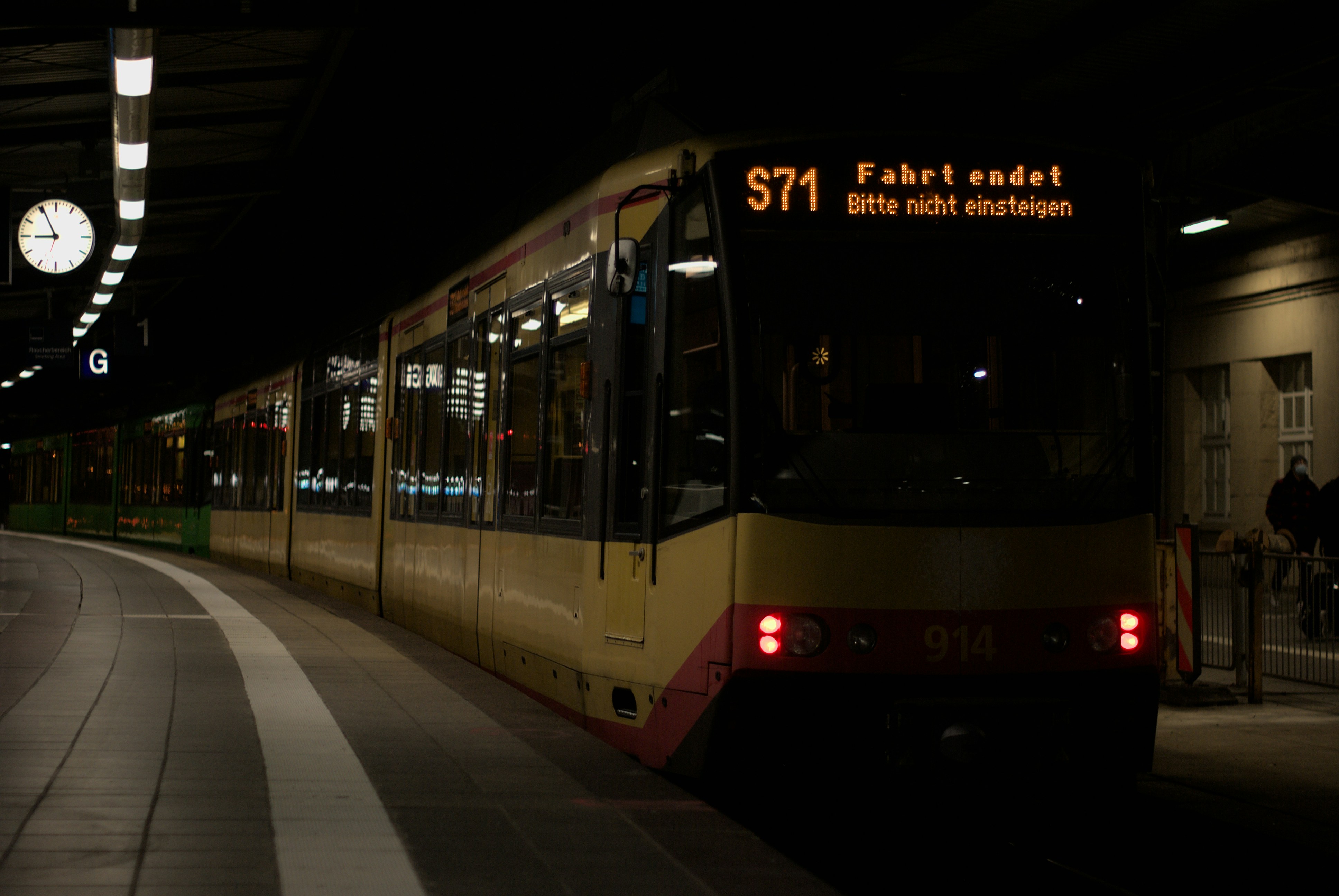 a train pulling into a train station at night