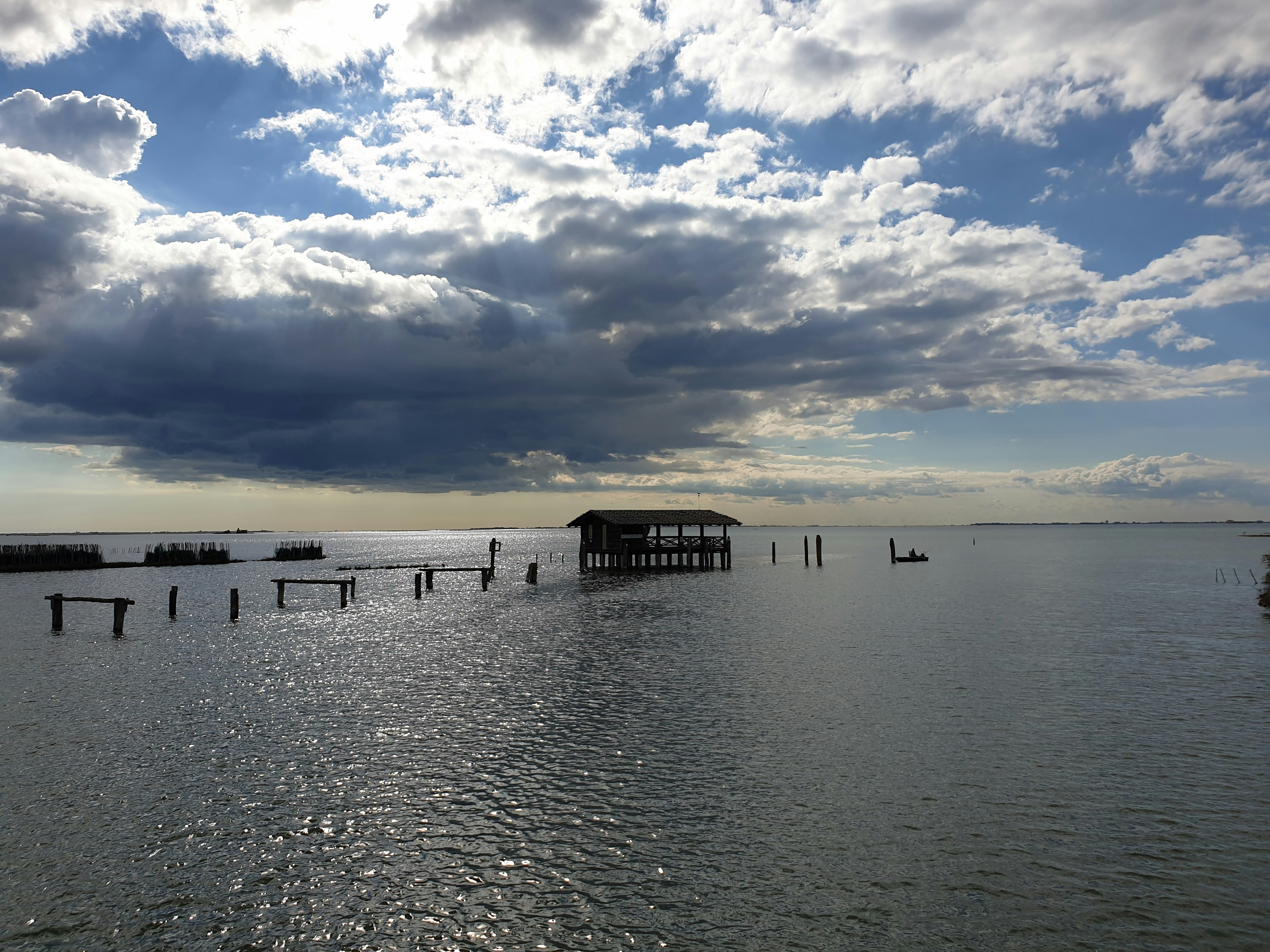 a large body of water with a pier in the middle of it