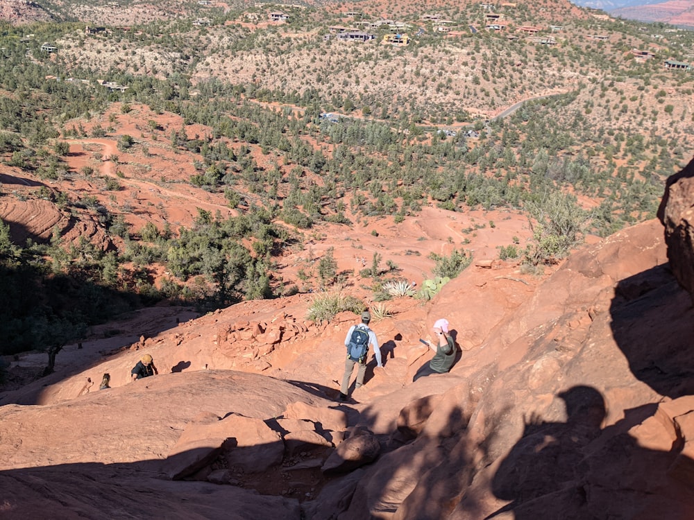 a group of people climbing up the side of a mountain