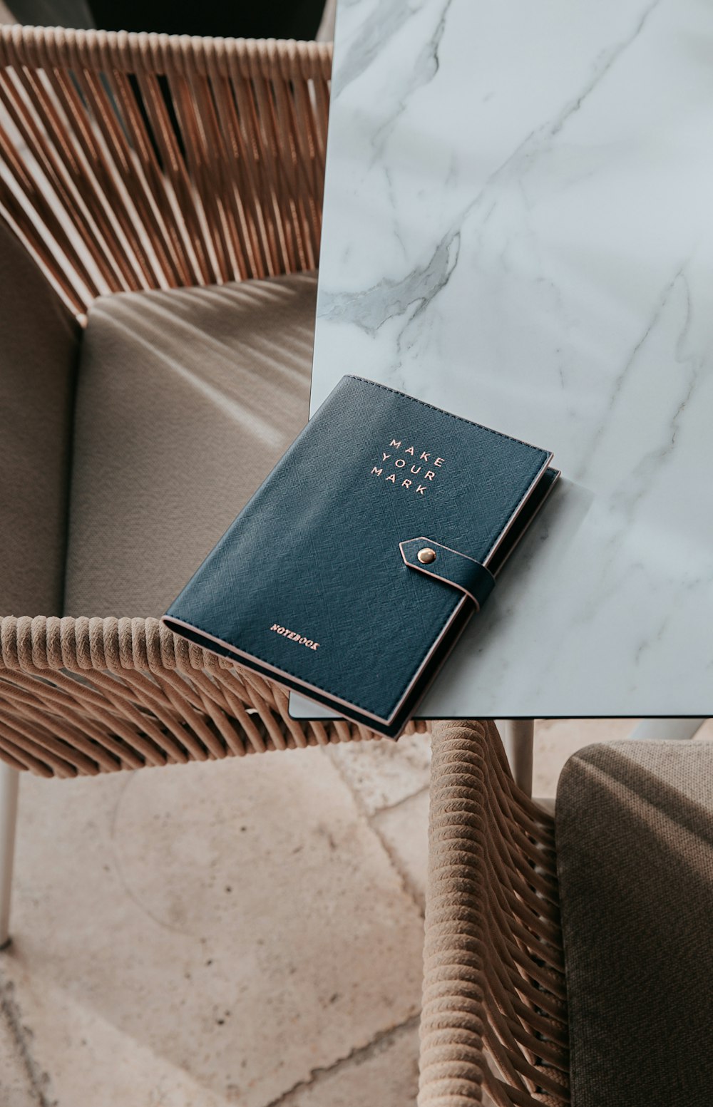 a book sitting on top of a table next to a chair